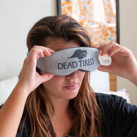 Young girl putting on her face a 3d sleep mask